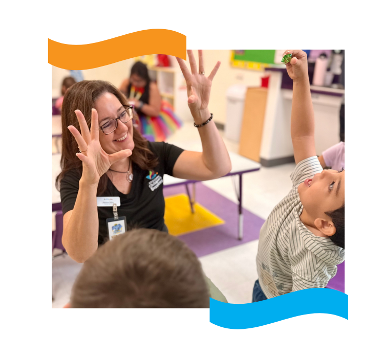 An ECS4Kids teacher counting on her fingers with a child in a classroom