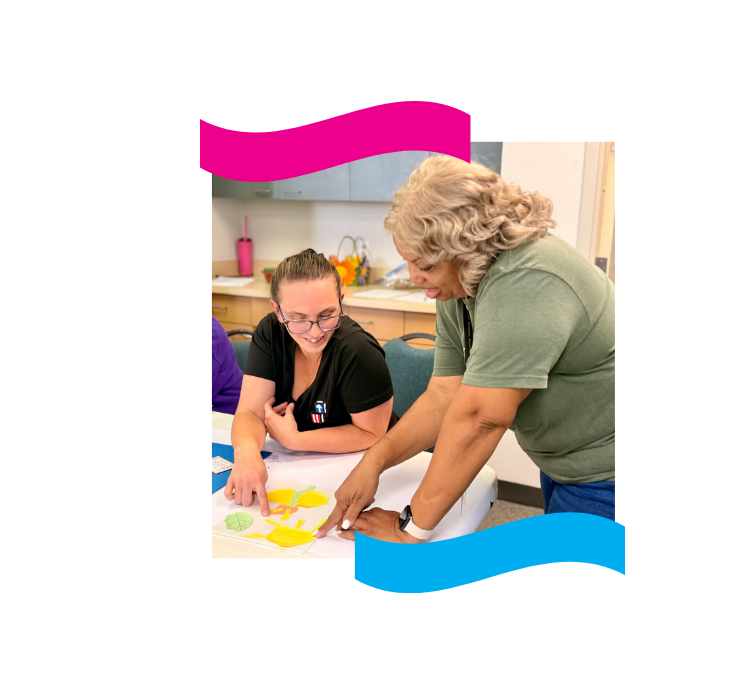 An ECS4Kids trainer working through learning materials with a teacher